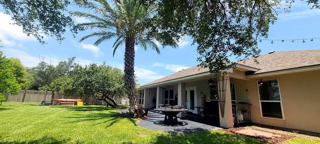 a view of a backyard with table and chairs and a fire pit