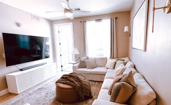a living room with furniture and a flat screen tv