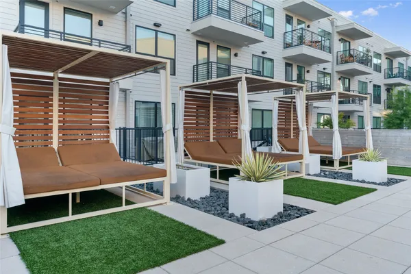 a front view of a house with a garden and sitting area