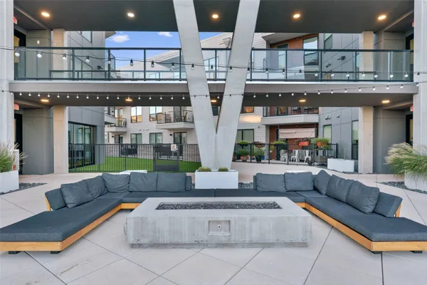 a living room with stainless steel appliances kitchen island granite countertop a couch and cabinets