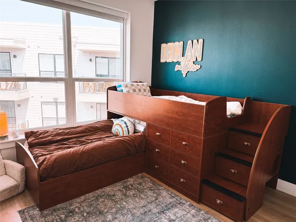 a bedroom with a bed and large window