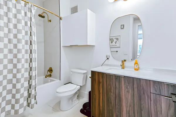 a bathroom with a sink a toilet and shower curtain