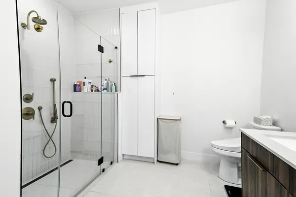 a bathroom with a toilet sink and shower