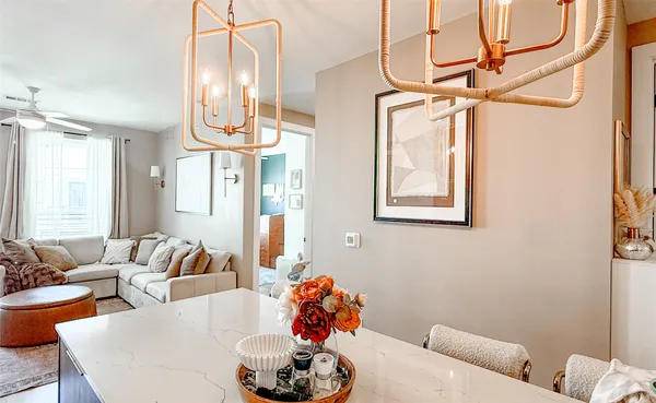 a living room with furniture and a chandelier