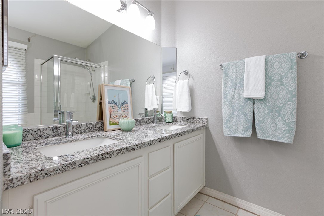 2254 Ramsgate Drive Henderson, NV 89074 - Photo 21 of 43 Granite counters and dual sinks provide ample space in this well-appointed bathroom.