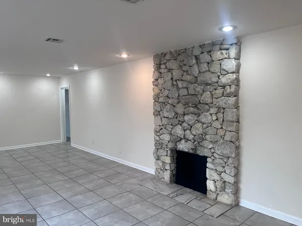 a view of empty room with fireplace