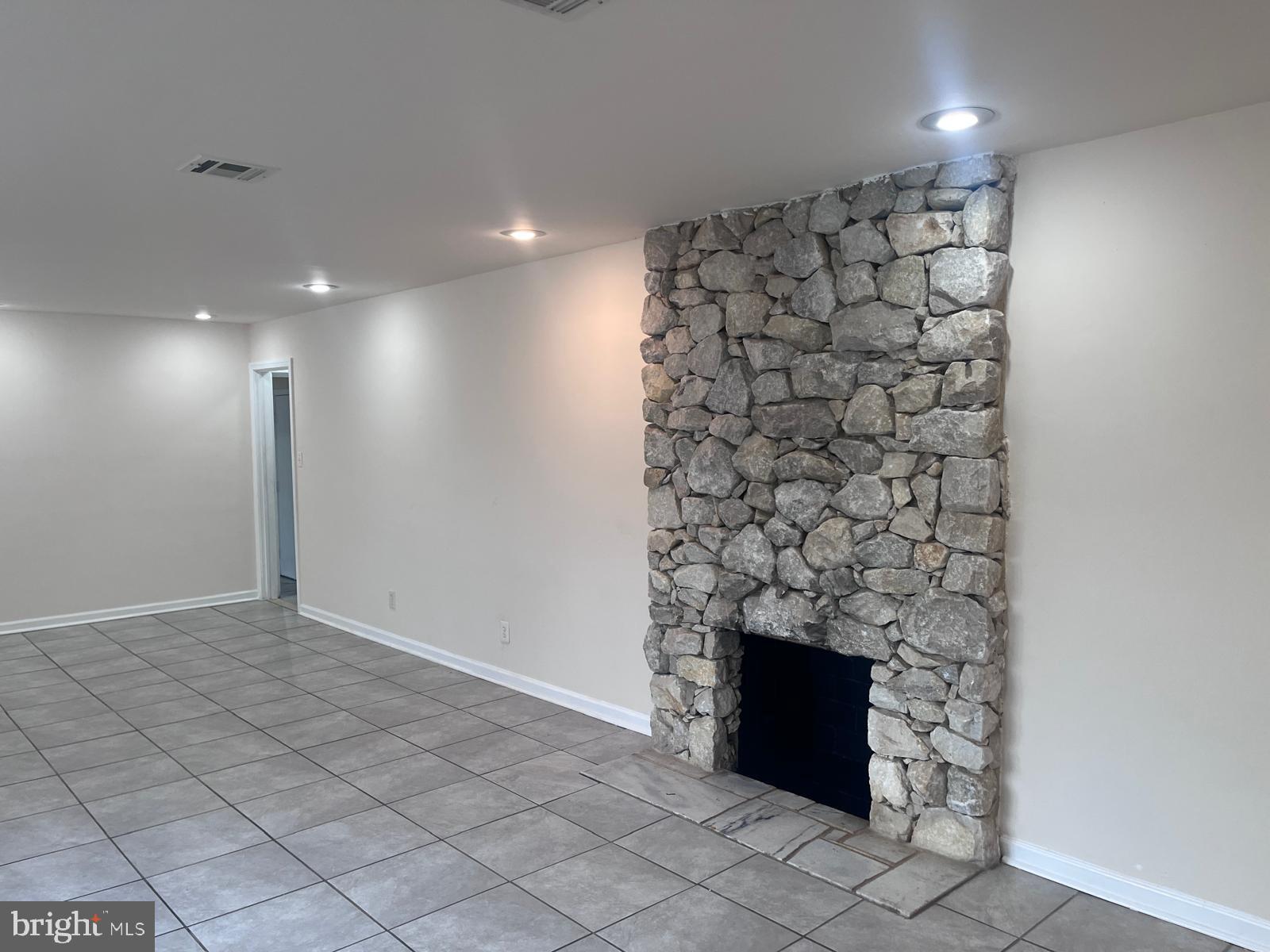 8617 Woodyard Road Clinton, MD 20735 - Photo 14 of 51 a view of empty room with fireplace