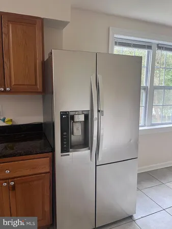 a white refrigerator freezer and a stove sitting inside of a kitchen