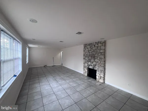 a view of a room with a fireplace and window