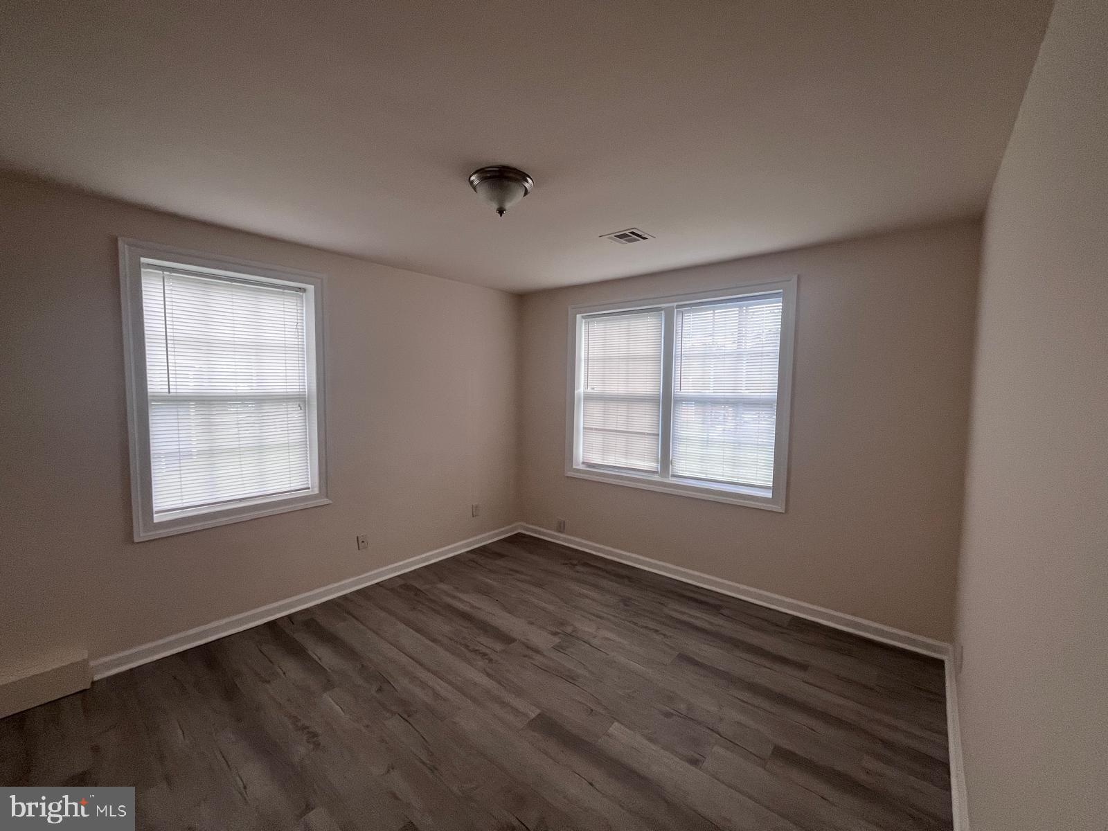 8617 Woodyard Road Clinton, MD 20735 - Photo 28 of 51 a view of an empty room with wooden floor and a window