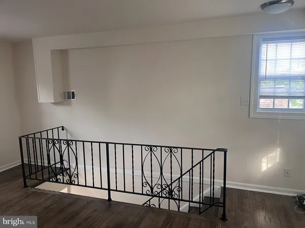 a view of staircase with white walls and window