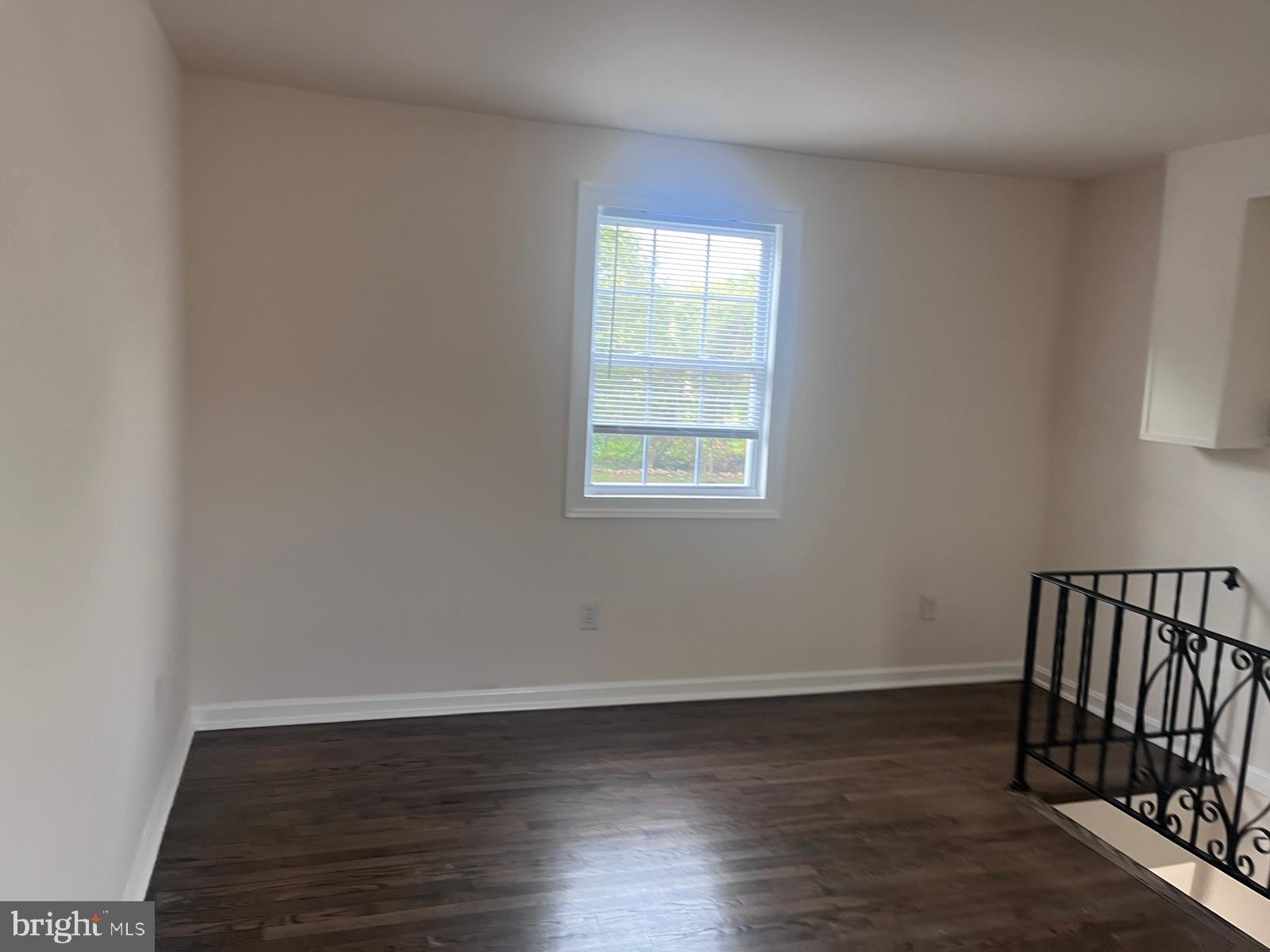 8617 Woodyard Road Clinton, MD 20735 - Photo 5 of 51 a view of an empty room with wooden floor and a window