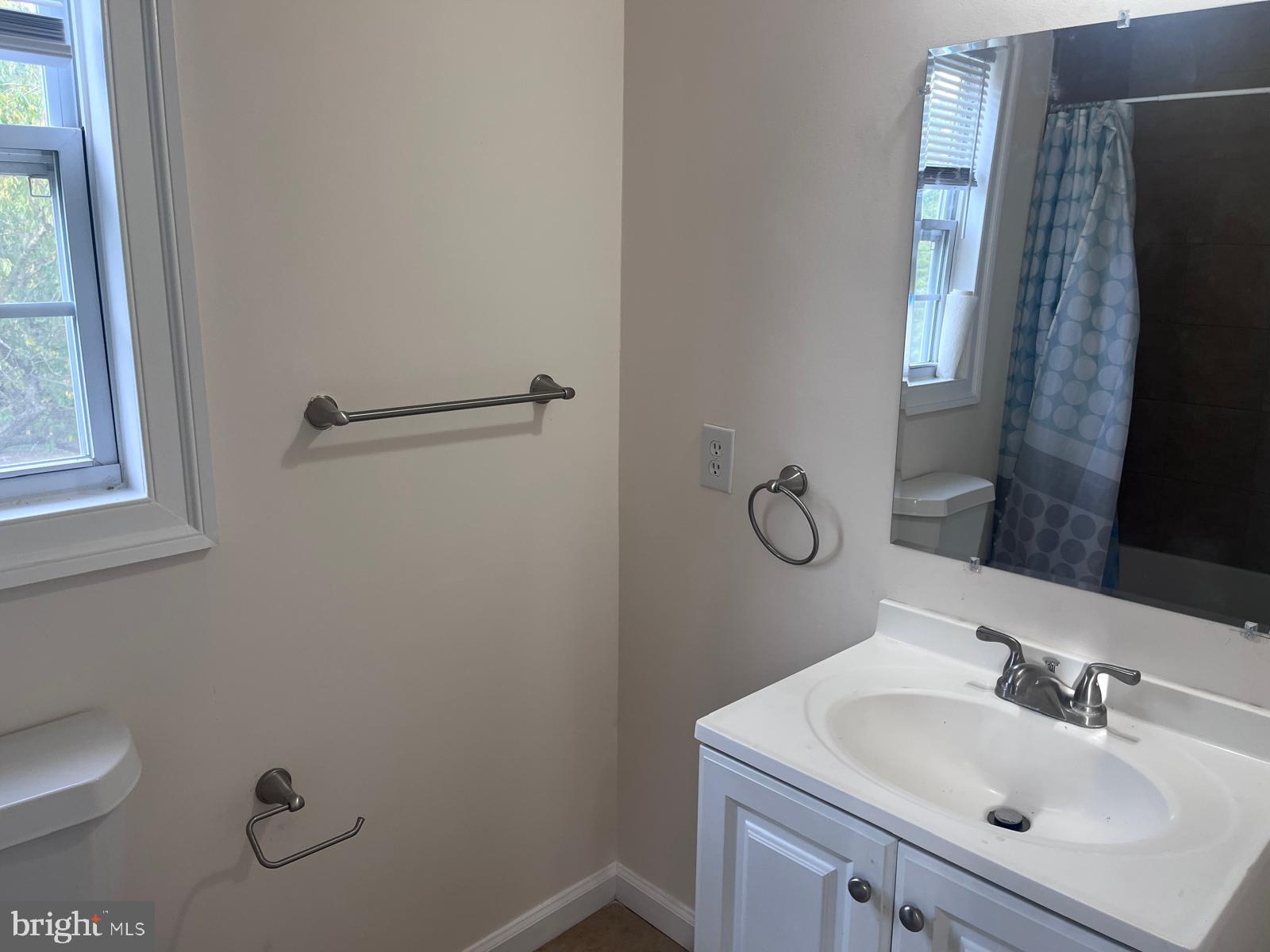 8617 Woodyard Road Clinton, MD 20735 - Photo 8 of 51 a bathroom with a sink toilet and mirror