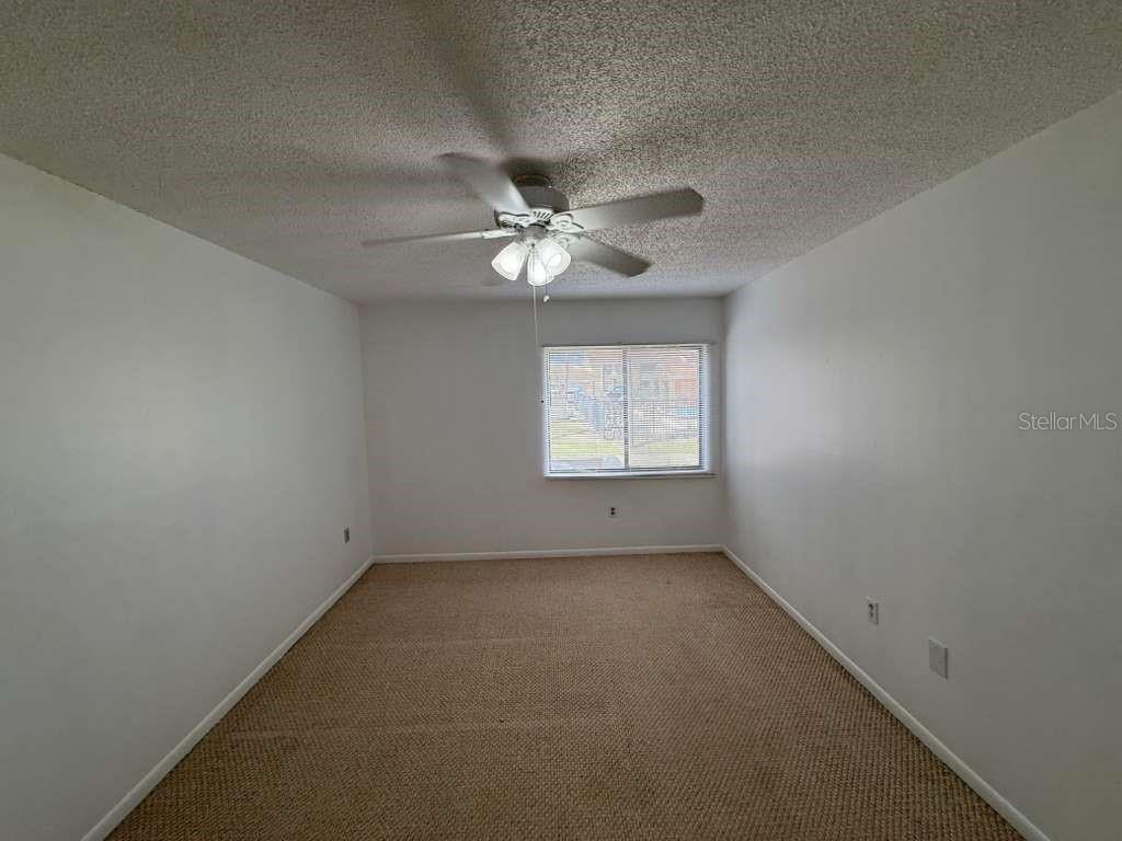 5333 Vineland Road, Unit 101 Orlando, FL 32811 - Photo 12 of 19 an empty room with windows and ceiling fan