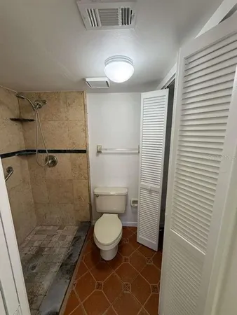 a bathroom with a toilet and a shower