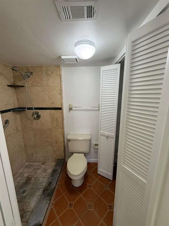 5333 Vineland Road, Unit 101 Orlando, FL 32811 - Photo 14 of 19 a bathroom with a toilet and a shower