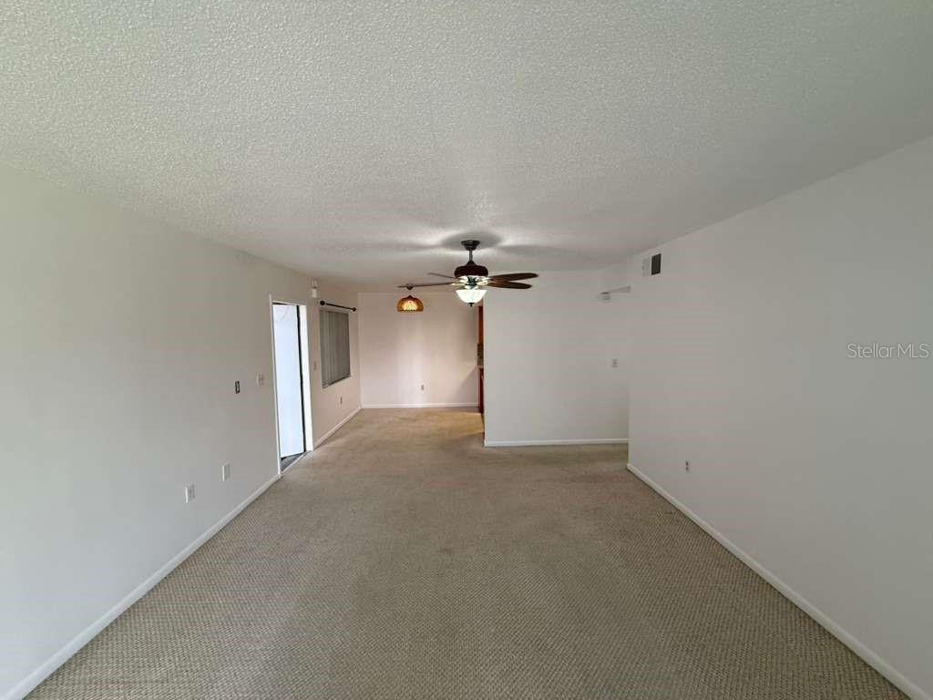 5333 Vineland Road, Unit 101 Orlando, FL 32811 - Photo 4 of 19 an empty room with a ceiling fan and a window