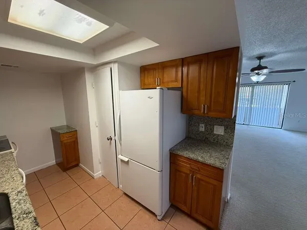 a kitchen with a refrigerator and a stove