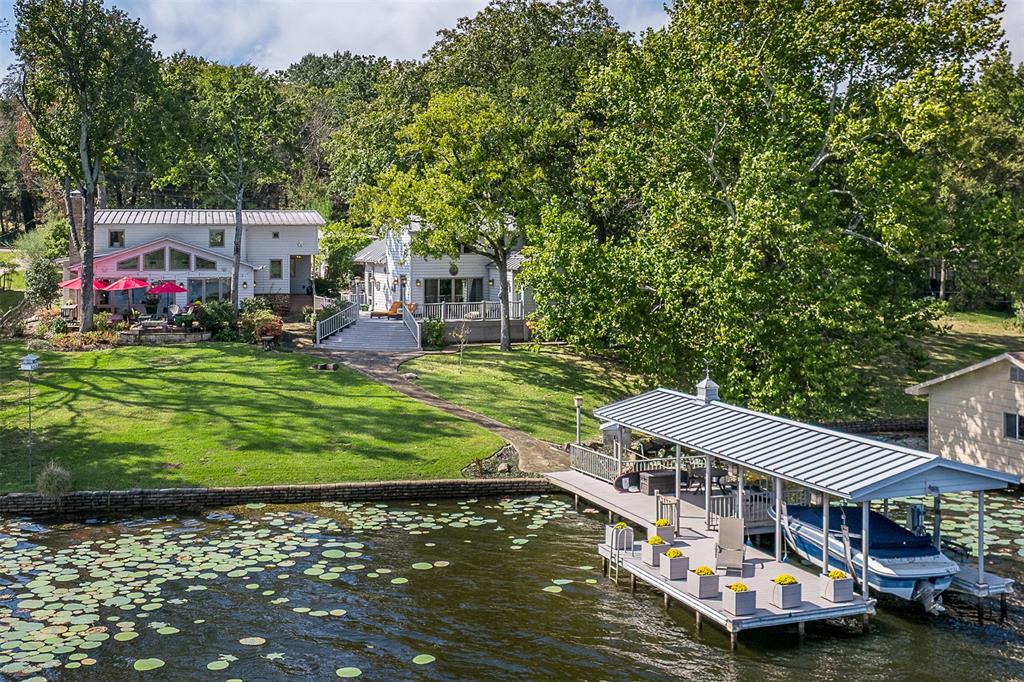 a view of a house with a yard deck and sitting area