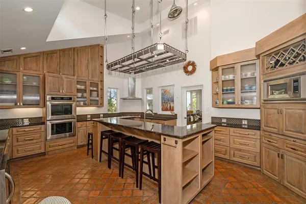 a kitchen with stainless steel appliances granite countertop a stove and cabinets