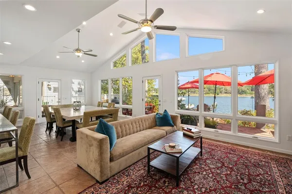 a living room with furniture ceiling fan and a rug