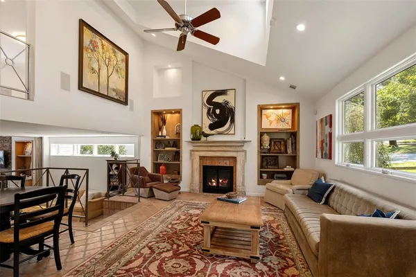a living room with furniture fireplace and flat screen tv