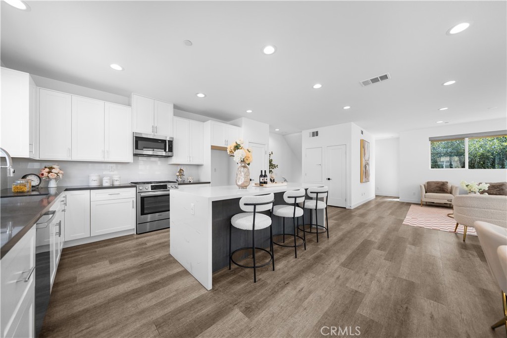 23238 Marigold Avenue Torrance, CA 90502 - Photo 11 of 38 a kitchen with a sink white cabinets and appliances