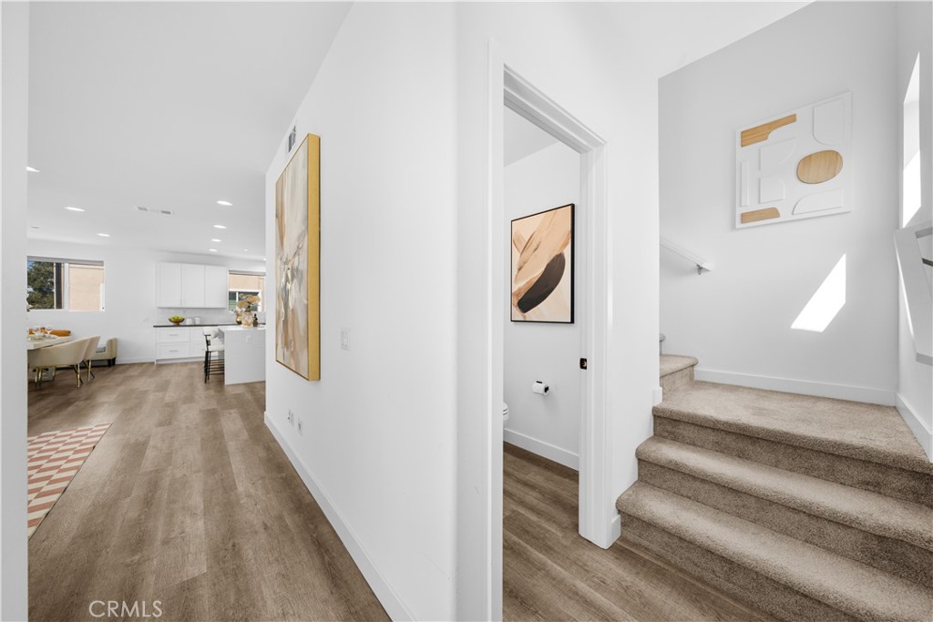 23238 Marigold Avenue Torrance, CA 90502 - Photo 20 of 38 a view of a hallway with wooden floor and staircase