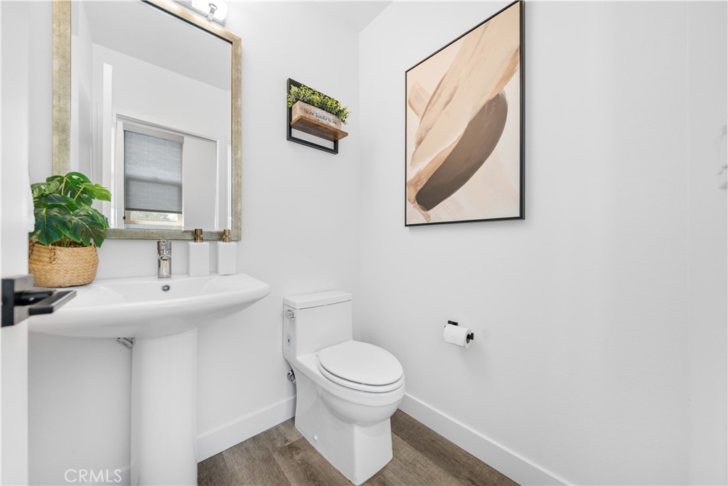 23238 Marigold Avenue Torrance, CA 90502 - Photo 21 of 38 a bathroom with a toilet a sink and mirror