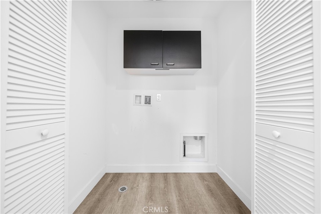 23238 Marigold Avenue Torrance, CA 90502 - Photo 22 of 38 a view of a hallway with wooden floor and cabinets