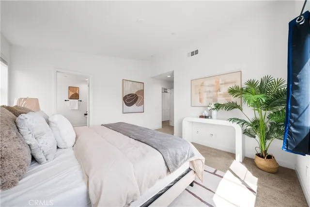 a spacious bathroom with a double vanity sink a mirror and a shower