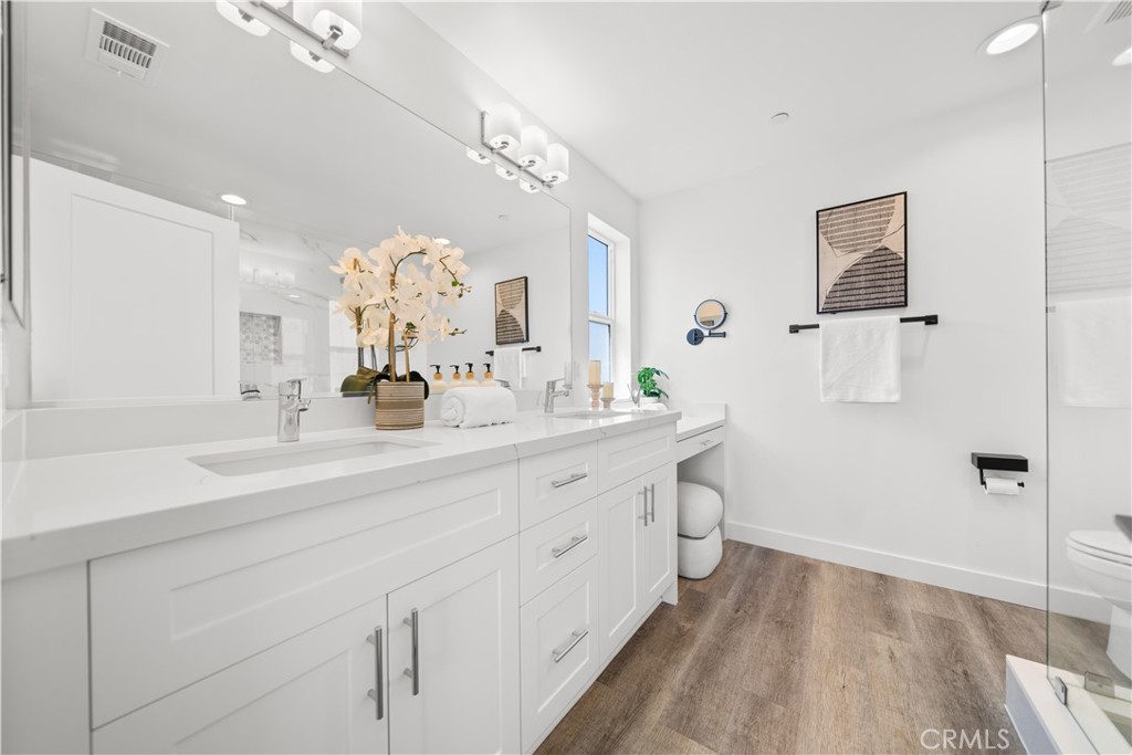 23238 Marigold Avenue Torrance, CA 90502 - Photo 27 of 38 a spacious bathroom with a double vanity sink a mirror and a shower