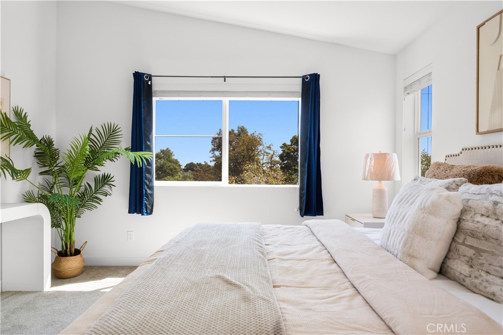 23238 Marigold Avenue Torrance, CA 90502 - Photo 29 of 38 a bedroom with a large bed and a potted plant
