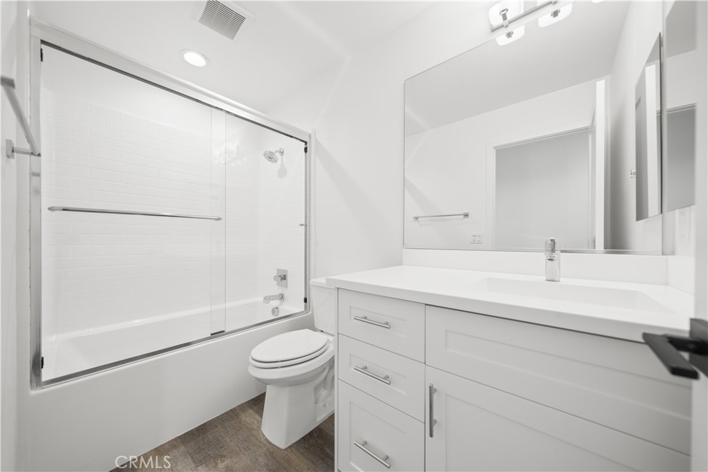 23238 Marigold Avenue Torrance, CA 90502 - Photo 30 of 38 a bathroom with a sink a toilet and a large mirror
