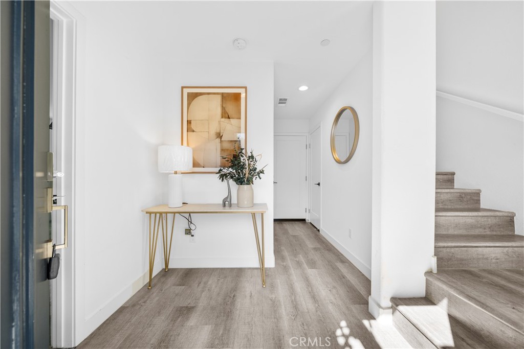 23238 Marigold Avenue Torrance, CA 90502 - Photo 6 of 38 a view of a hallway with wooden floor and staircase