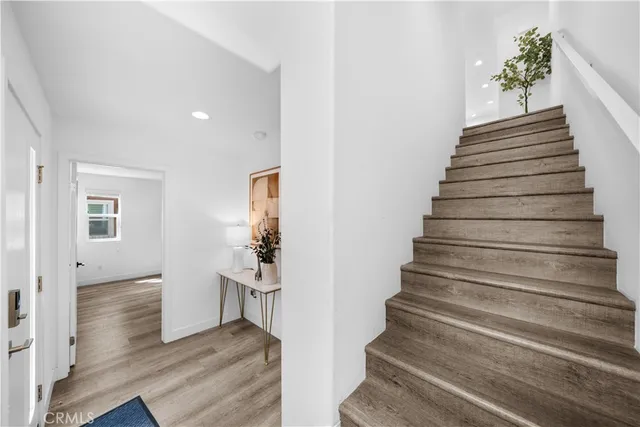 a view of entryway and hall with wooden floor