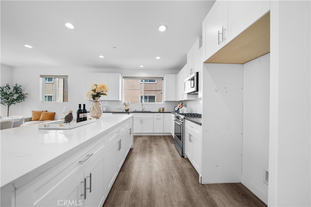 23238 Marigold Avenue Torrance, CA 90502 - Photo 9 of 38 a large kitchen with stainless steel appliances lots of counter space and a sink