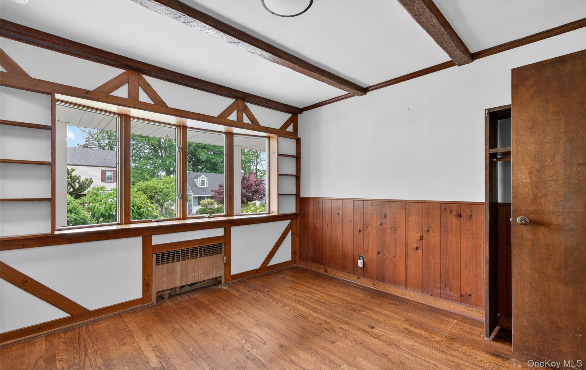 24 Purdue Road Glen Cove, NY 11542 - Photo 21 of 41 an empty room with wooden floor and windows