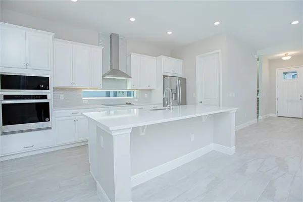 a kitchen with stainless steel appliances a sink stove and cabinets