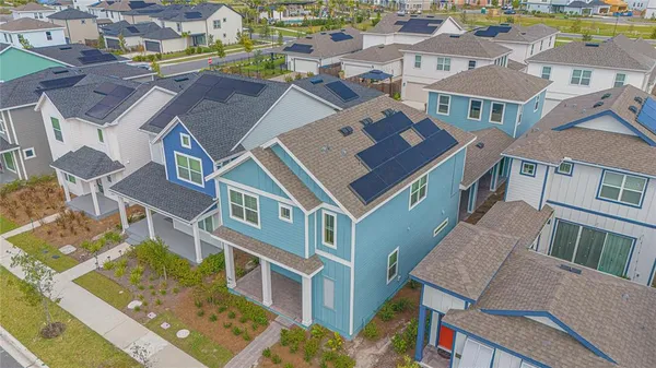 an aerial view of residential houses with outdoor space