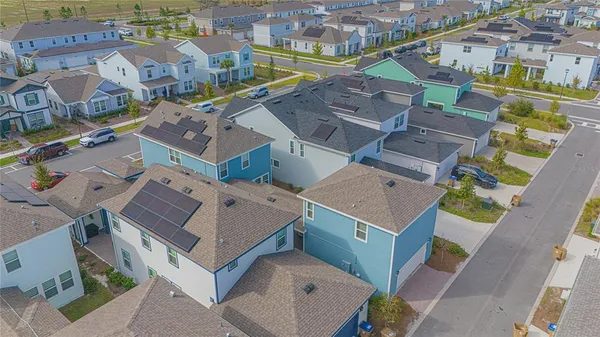 an aerial view of a houses with a city