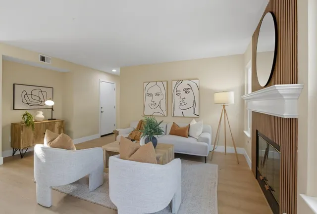 a living room with furniture a mirror and a fireplace