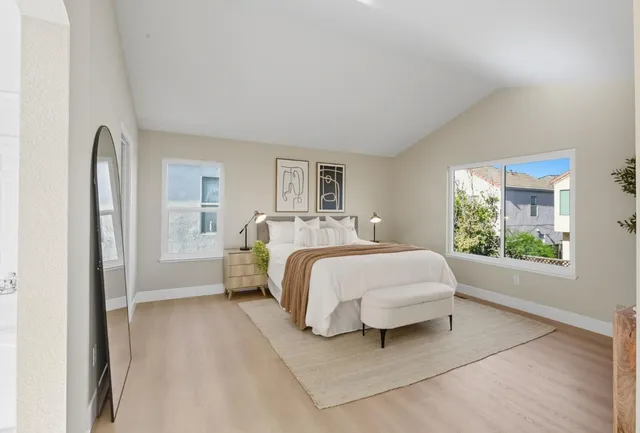 a bed room with a bed and a large window