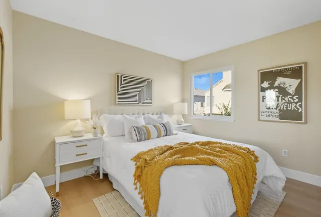 a spacious bedroom with a bed and a lamp