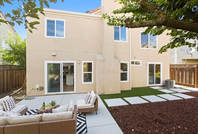 a view of a house with a couches and a small yard