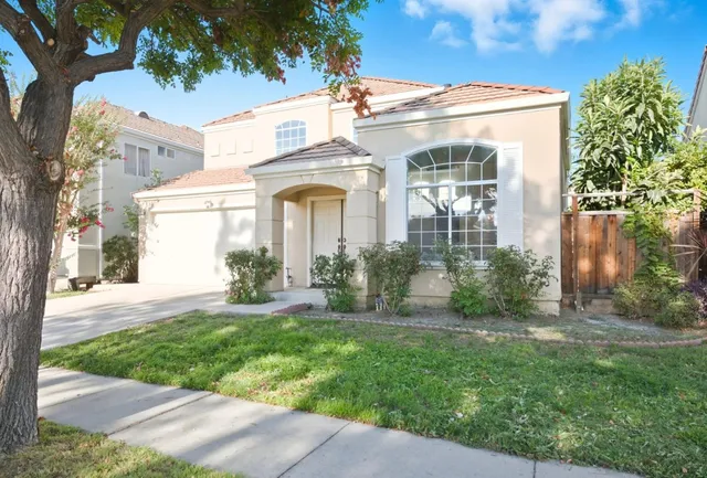 a front view of a house with a yard