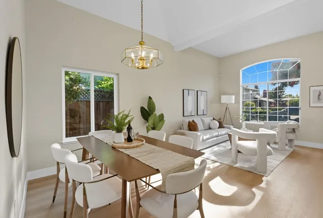 a view of a dining room with furniture wooden floor and chandelier
