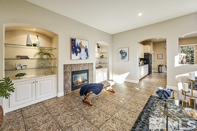 11380 Crotone Way Reno, NV 89521 - Photo 9 of 22 a living room with furniture a rug and a fireplace