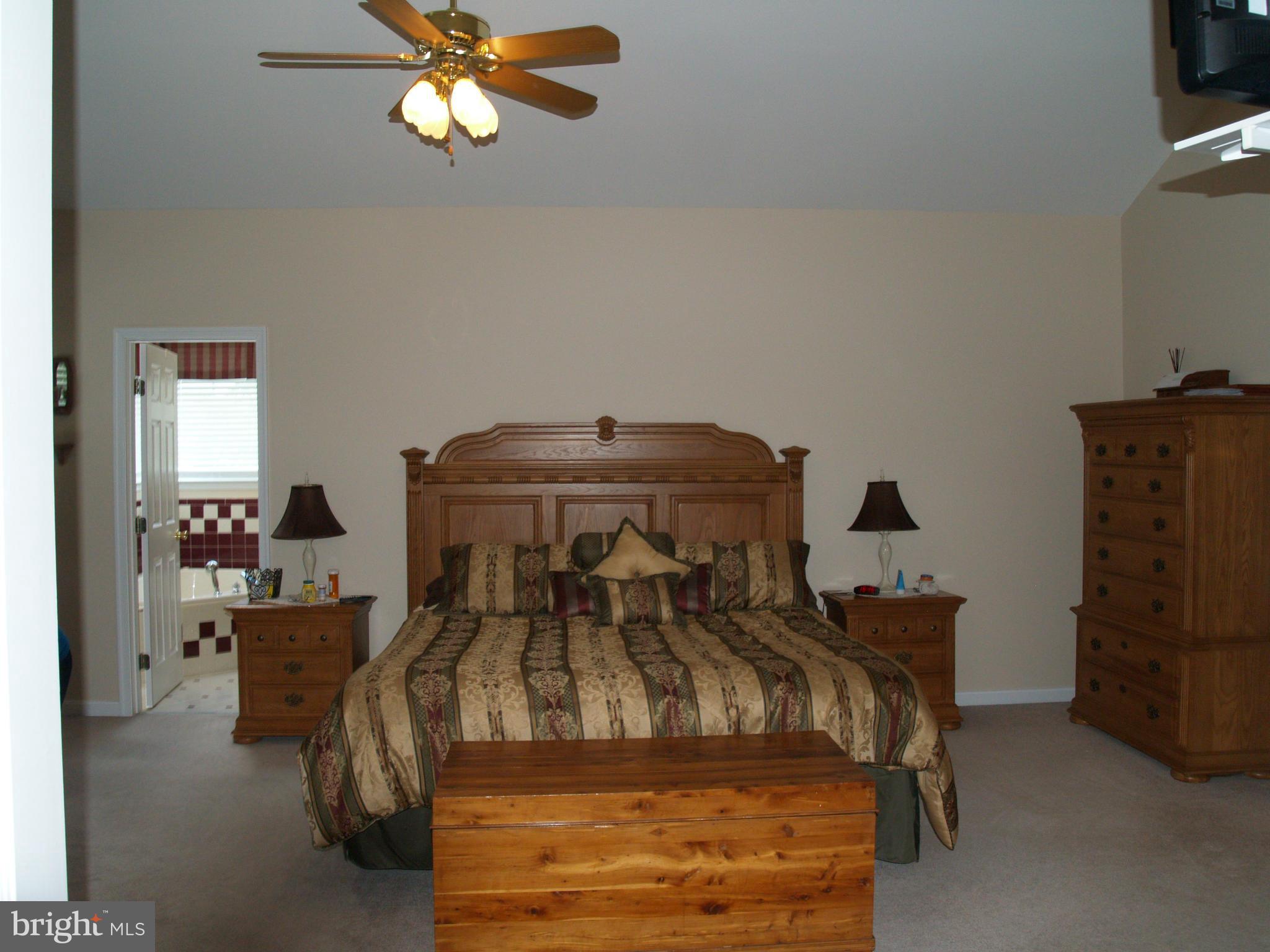 92 Friendship Road Friendship, MD 20758 - Photo 11 of 27 a bedroom with a bed and a chandelier