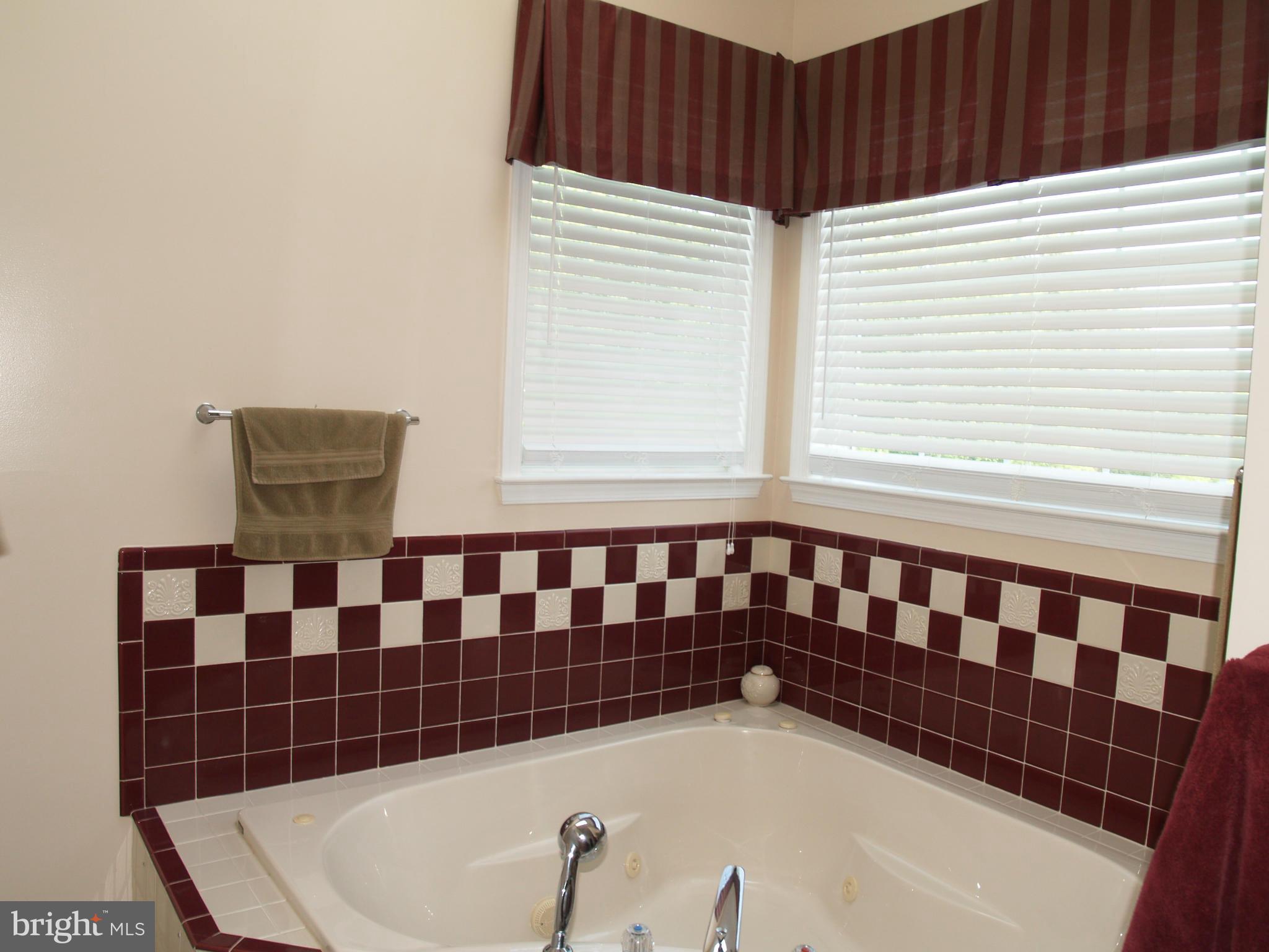 92 Friendship Road Friendship, MD 20758 - Photo 14 of 27 a bathroom with a bathtub and shower